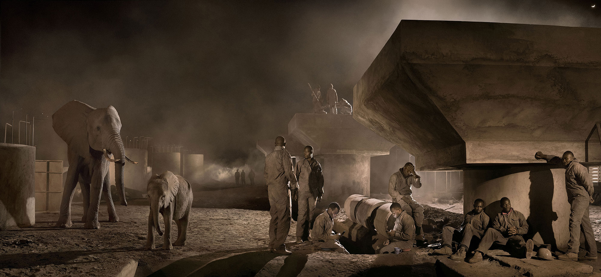 Bridge Construction with Elephants & Workers at Night. © Nick Brandt