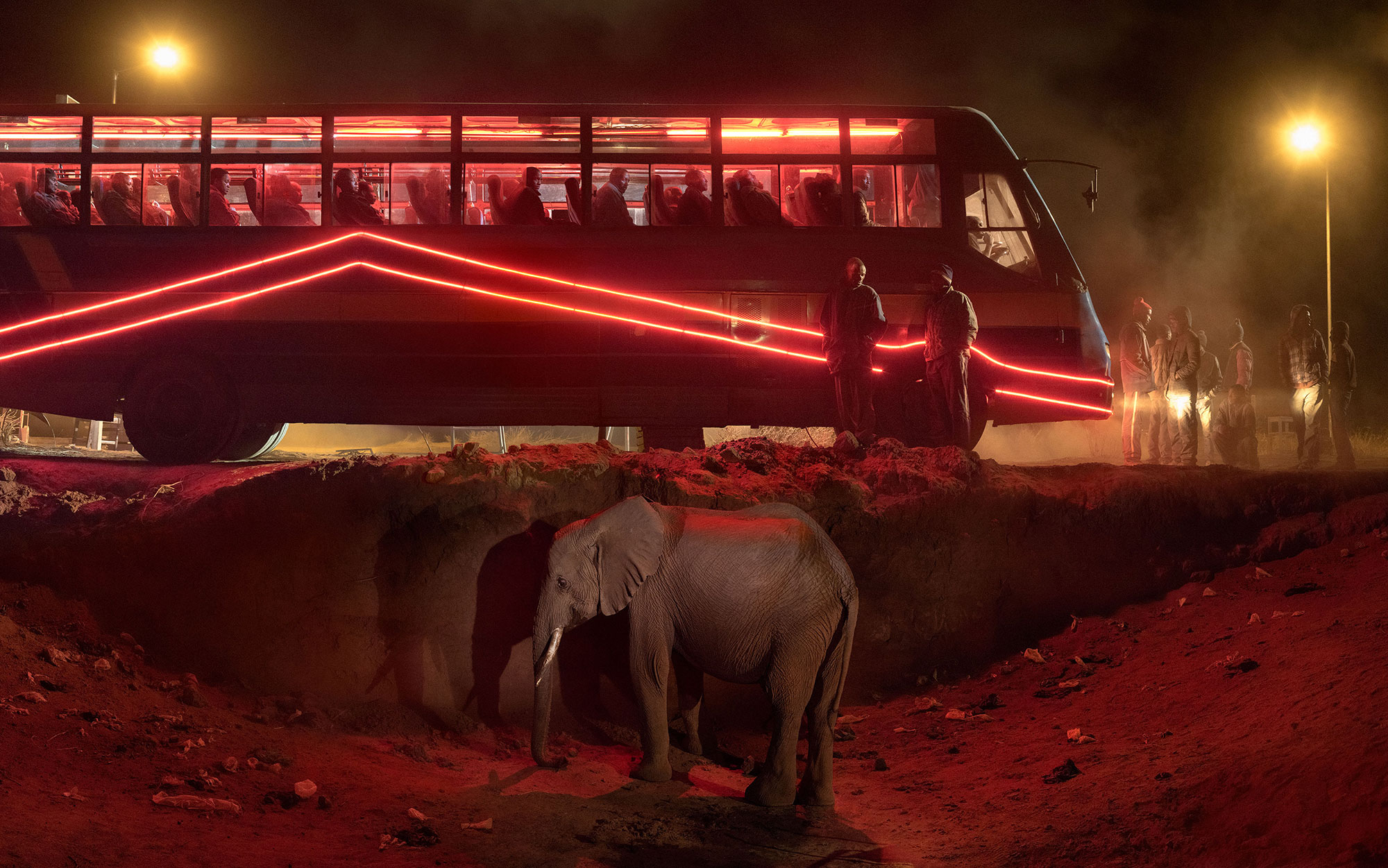 Bus Station with Elephant & Red Bus. © Nick Brandt