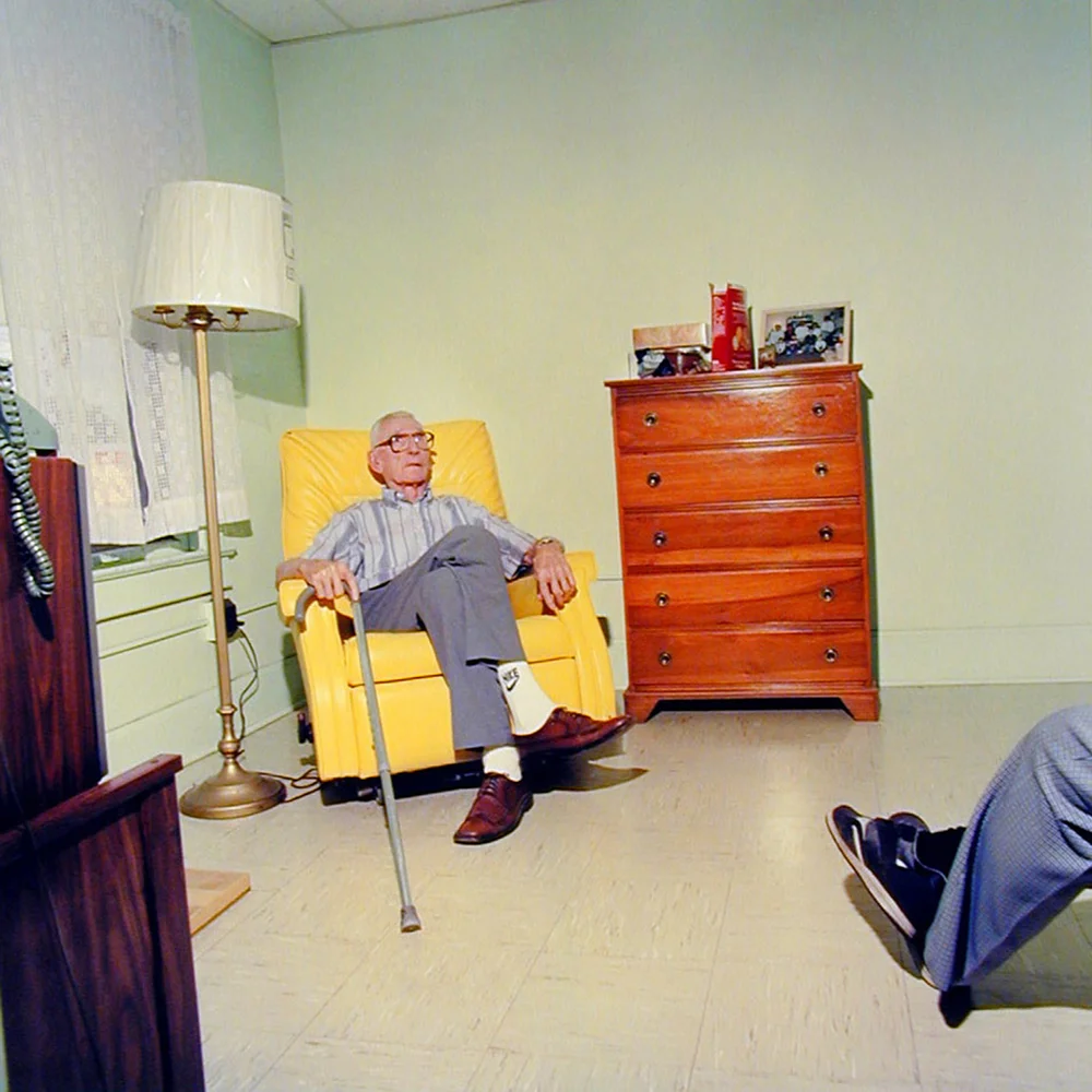 Chris Verene. Untitled, from Galesburg series, 1994. “Grandpa and I went to visit his friend, Turney, at the Millionaire’s Rest Home. They used to work on the railroad together.” C-print, 16 x 16 inches. Courtesy of PDNB Gallery, Dallas.