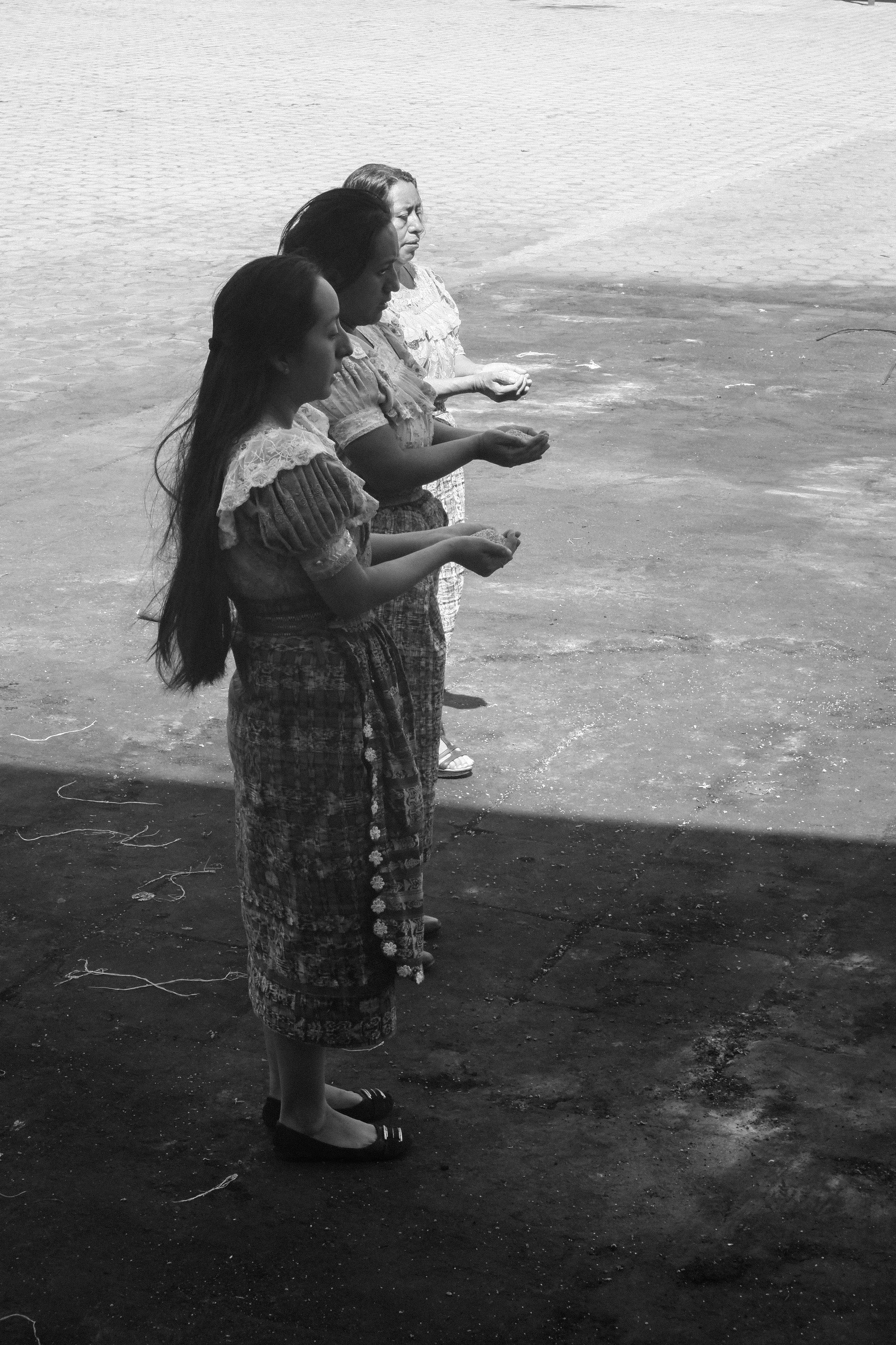 Three Maya women participate in a healing ceremony at Maximon, the San Simon Temple in San Andrés Itzapa, Guatemala. This is often the first step by the Maya in seeking the healthcare, a dysfunctional system that has greatly failed the Maya people by Guatemalan government. © Cory Zimmerman, Assade NGO