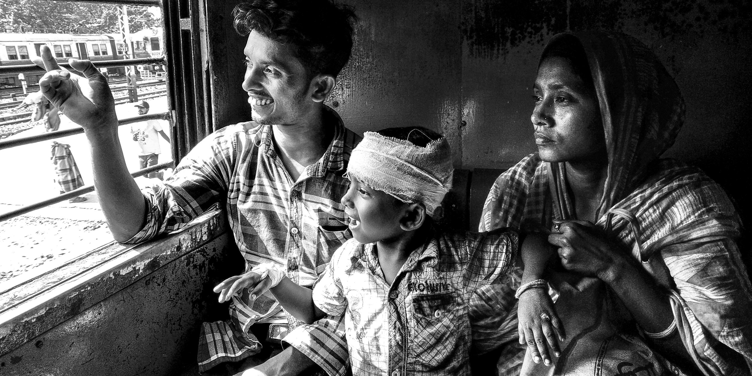  A father his showing his little boy something interesting outside the window and they are sharing the laughter. This family was sitting front of my sit in the Canning Local Train. The little boy is suffering in Head injury. Dad was very worried, but