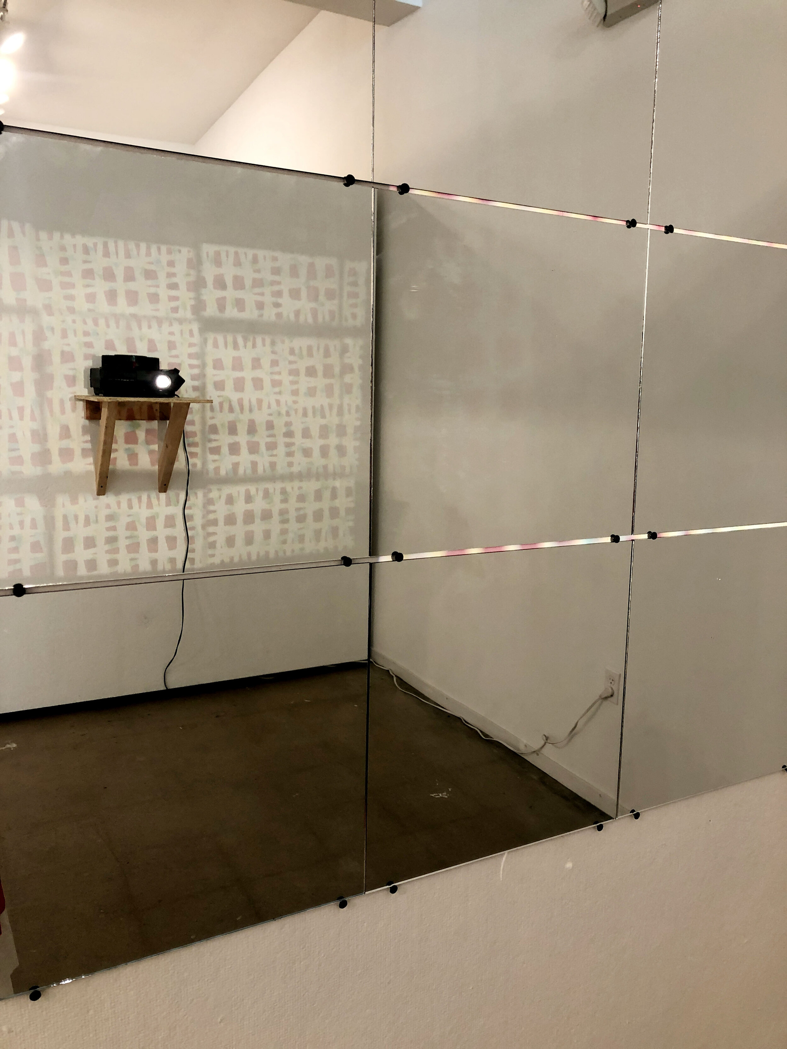  Reflected Projections Projecting Reflections, 2016 - Present, Modular installation, slide projector, slide transparencies, mirror tiles.  Image courtesy Tracey Morgan Gallery, Asheville, NC. 