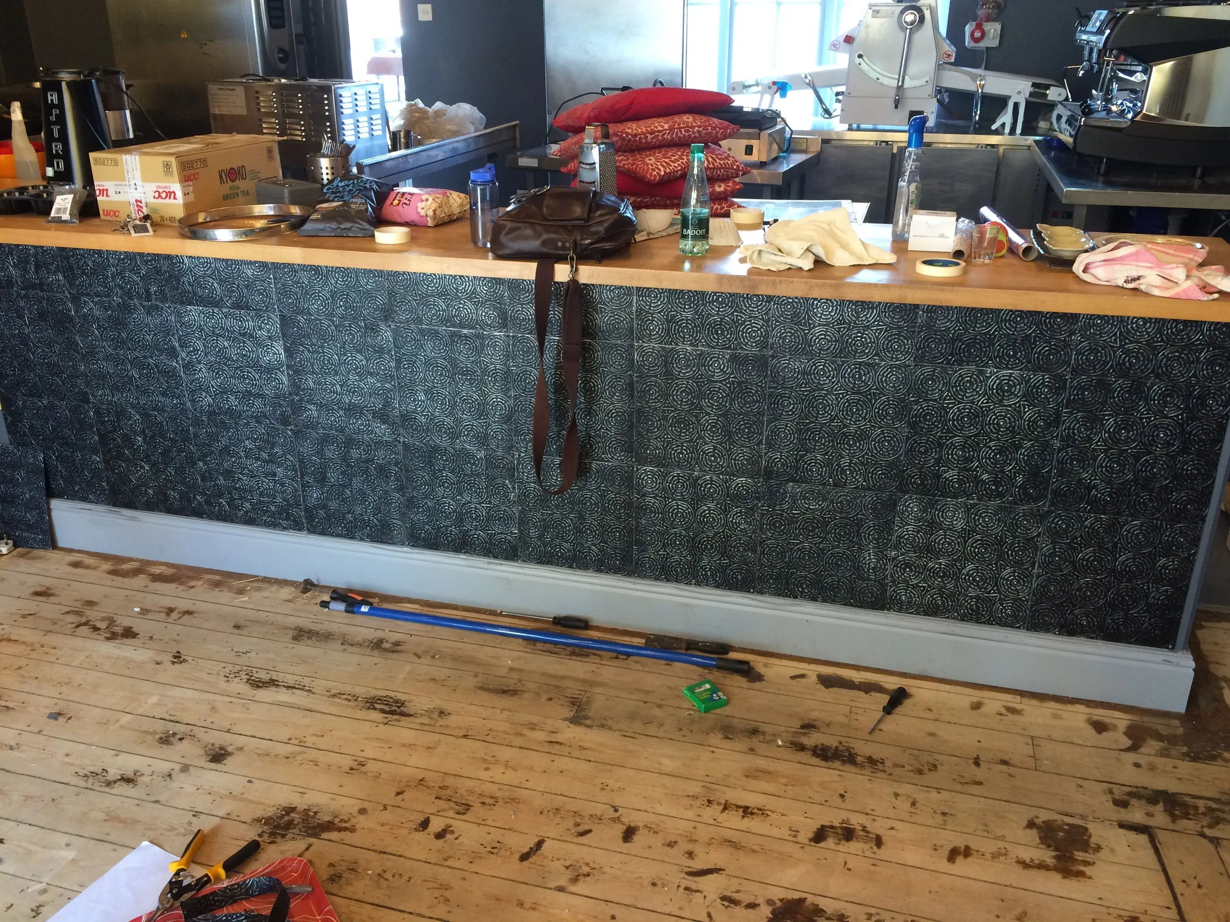 My lovely mother flew all the way from the USA to help hang these awesome tin tiles on the bar!