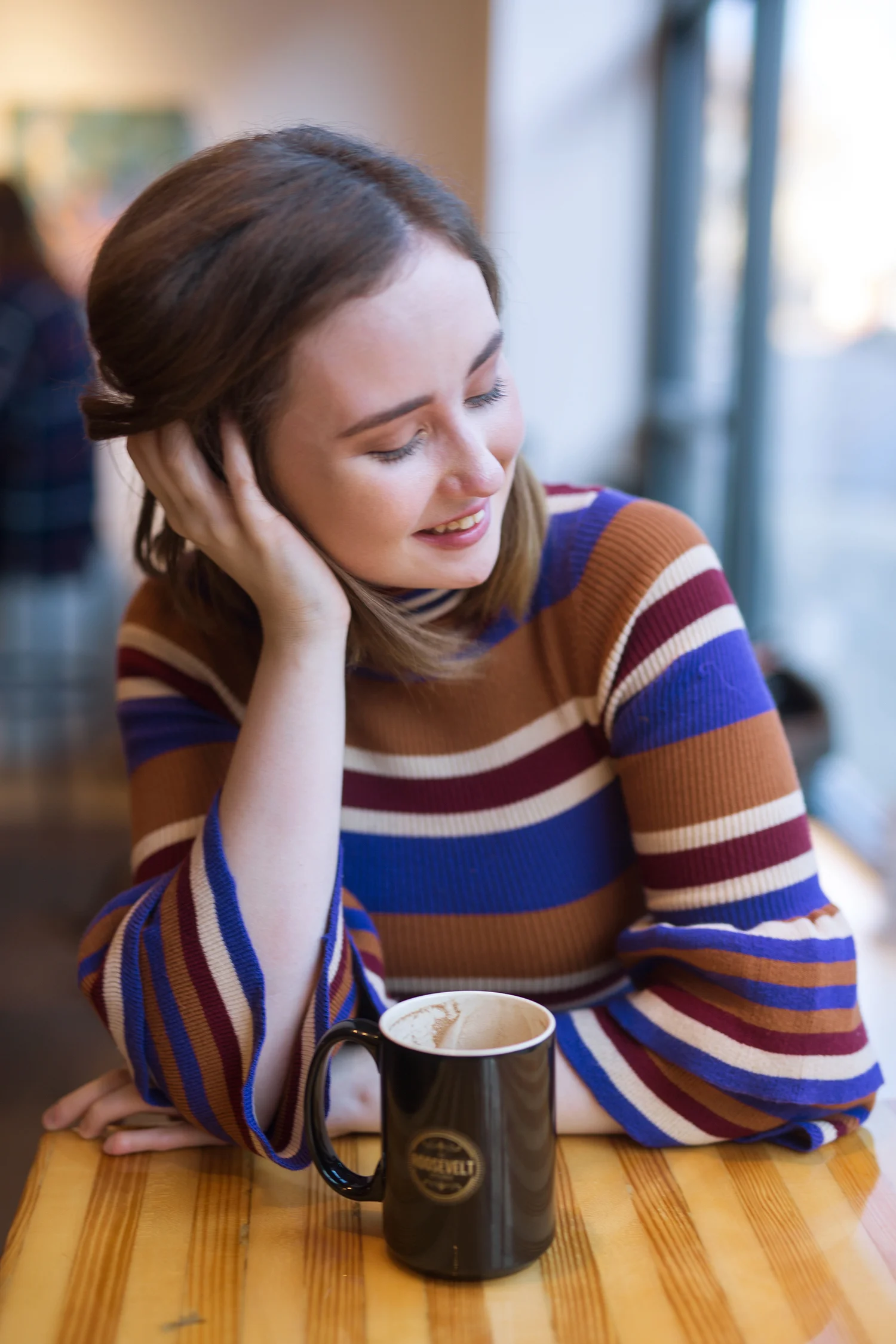 girl smiling at a table 