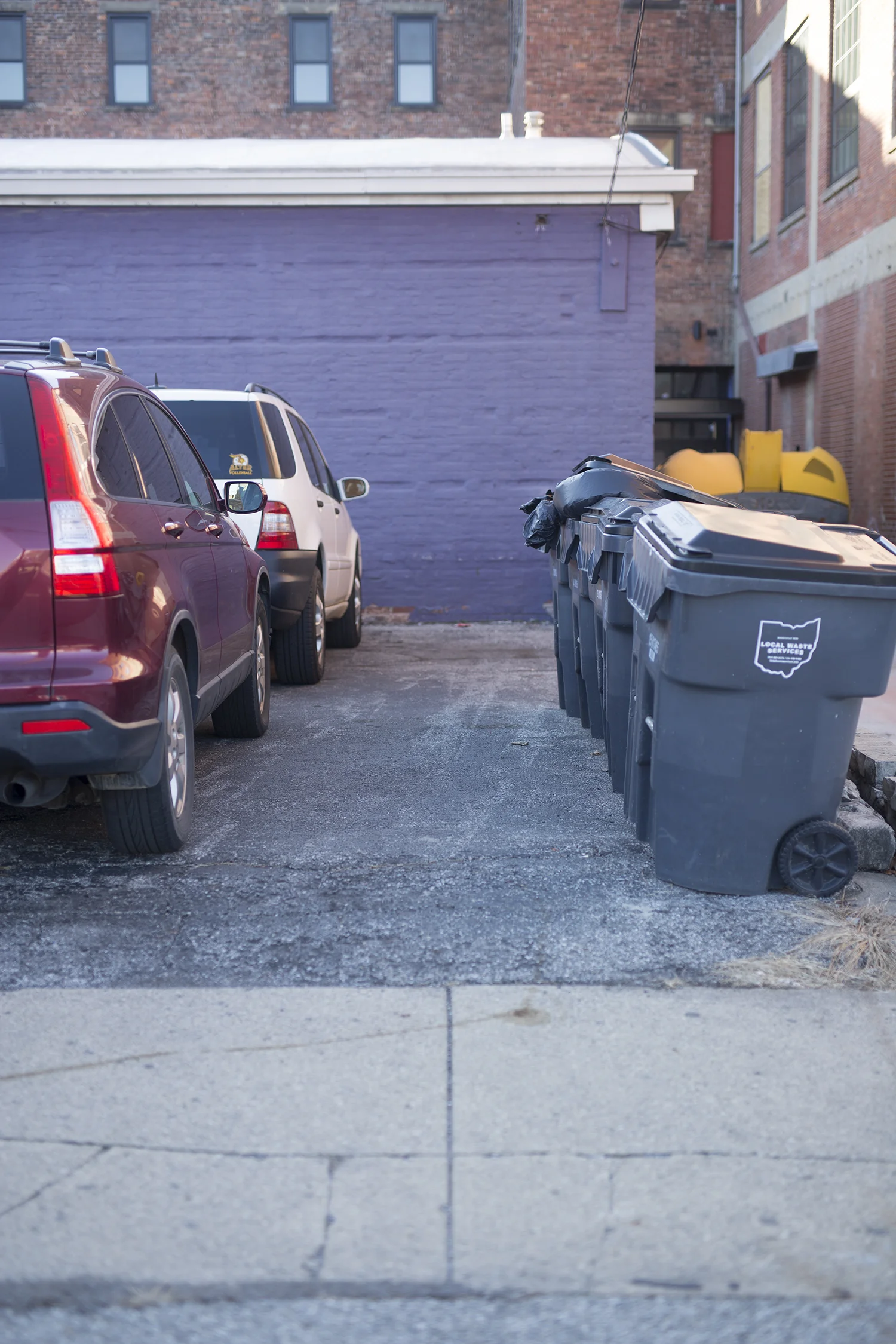 cars parked in front of a purple wall in downtown columbus, ohio