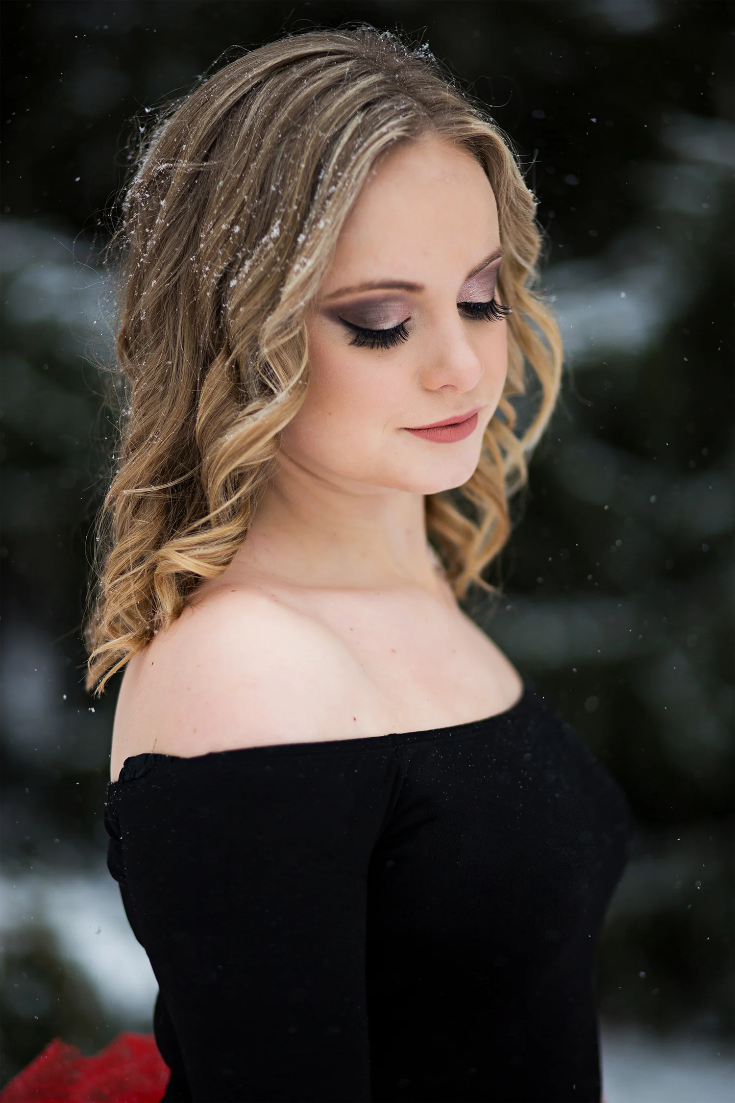 a girl looking down showing off her eye makeup.