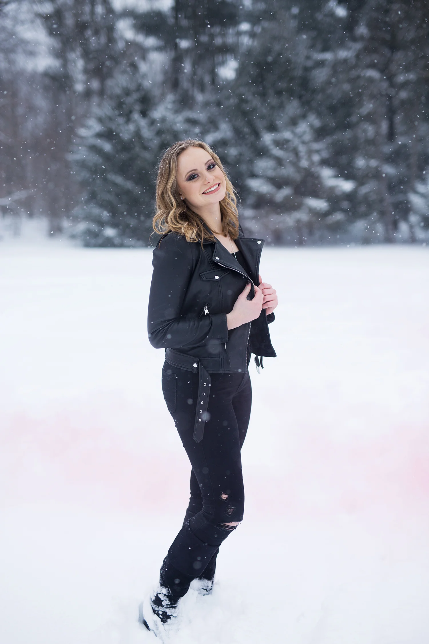 a senior girl smiling in the snow.