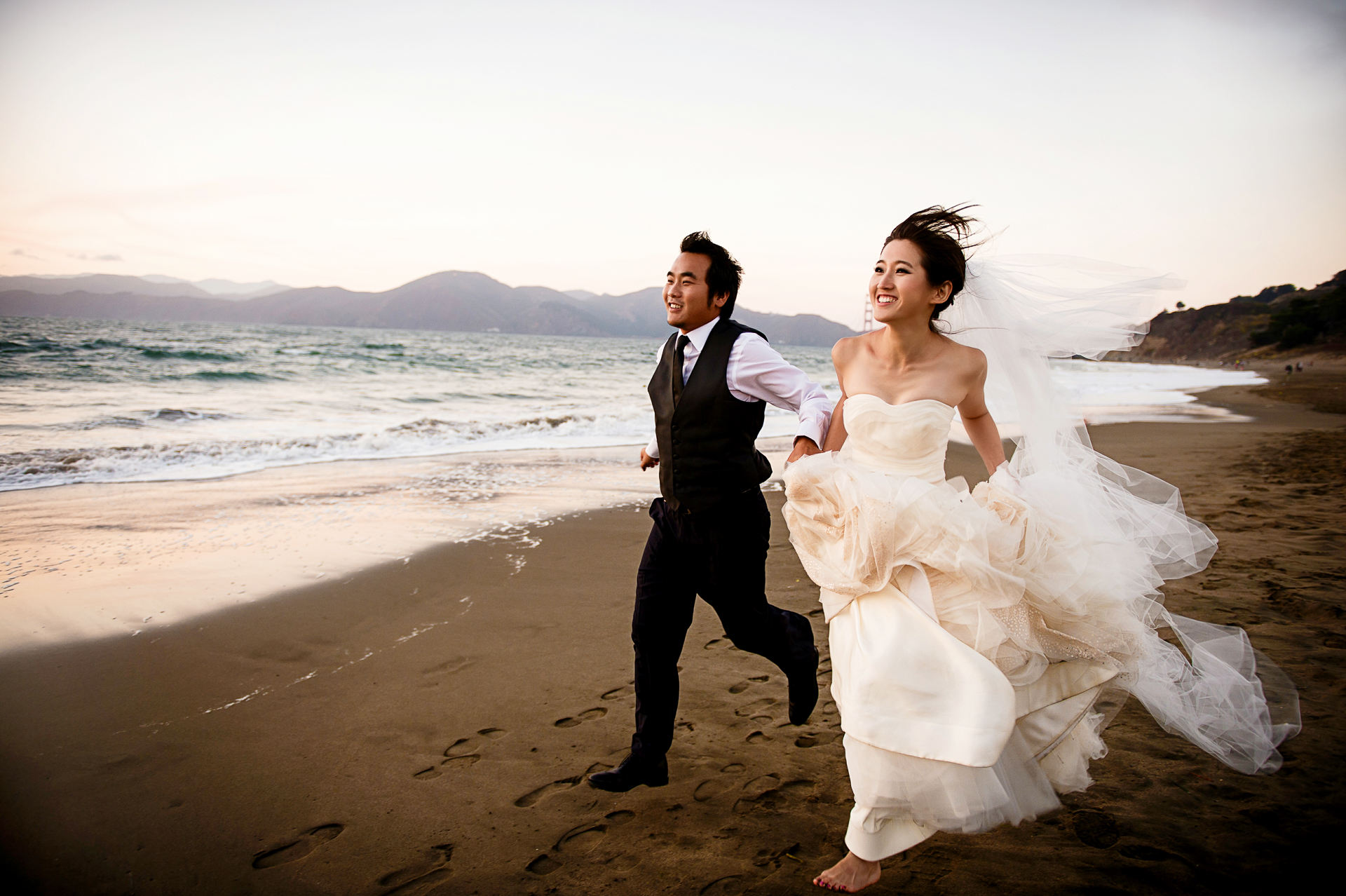 Pre Wedding Bride and groom running at Baker Beach