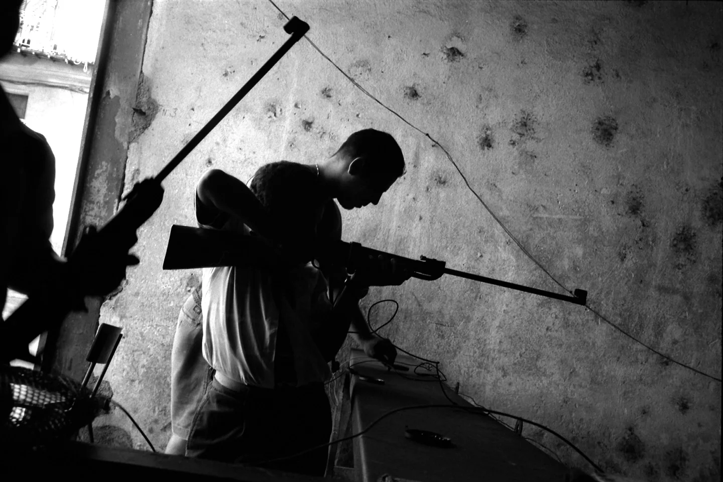 A group of schoolboys practice target shooting at a recreational gun range. Havana, Cuba.
