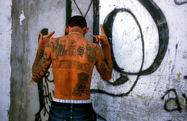 A member of Mara Salvatrucha (MS-13) shows off his tattoos, El Salvador.