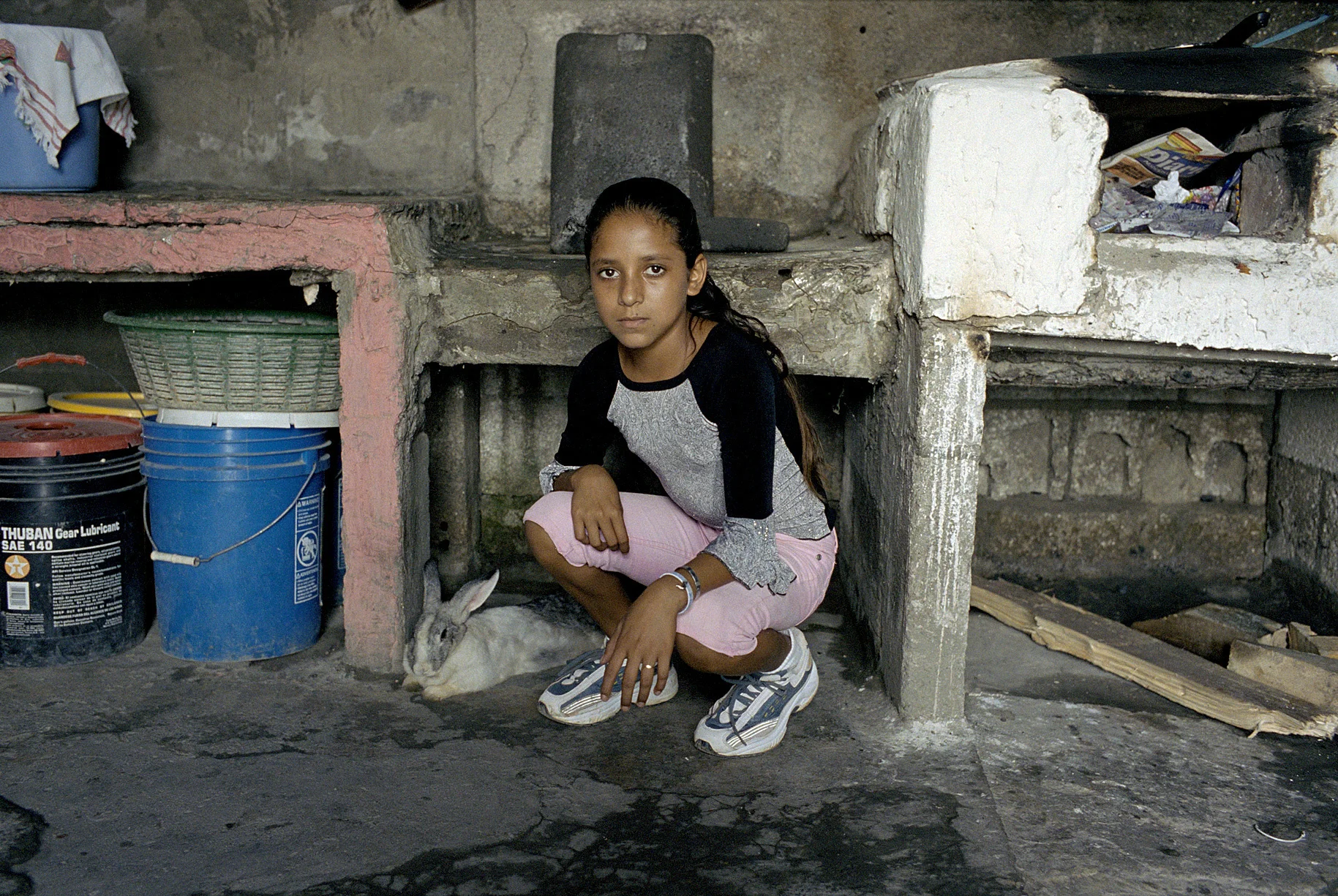 A young girl with her pet rabbit, El Salvador.