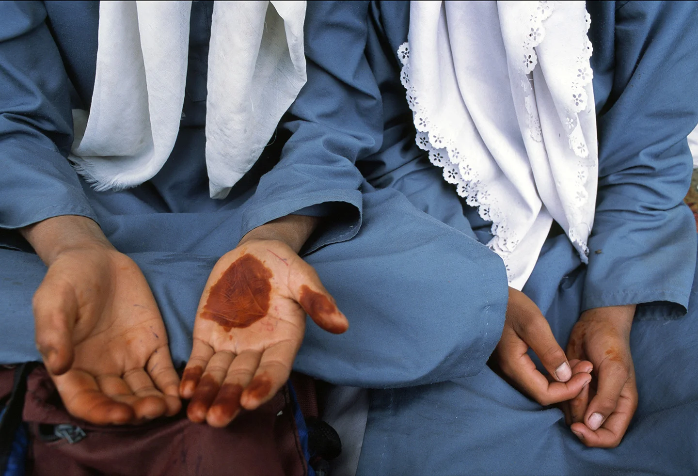 School girls with henna on their palms, Kashmir.