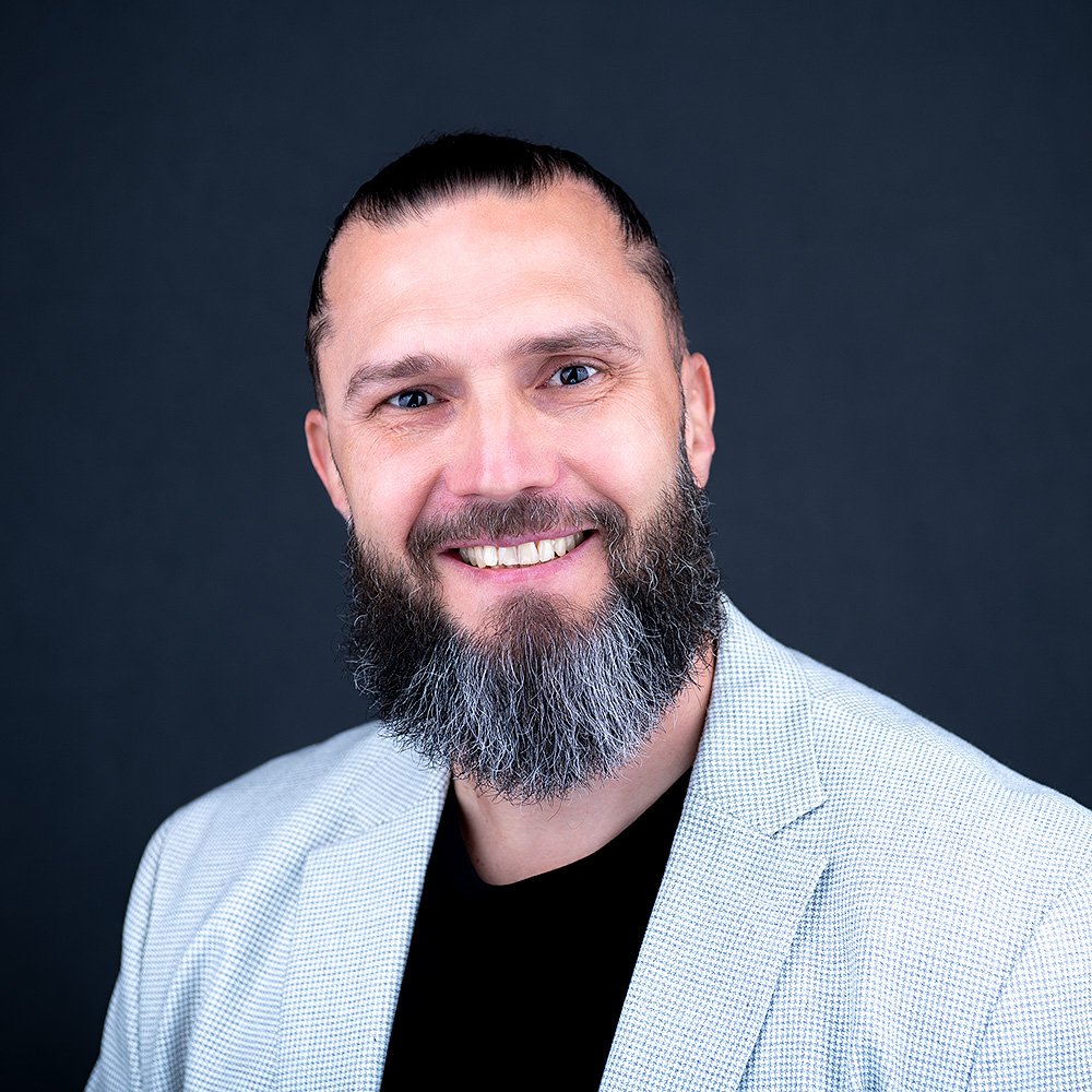 Clean professional headshot for executive profile