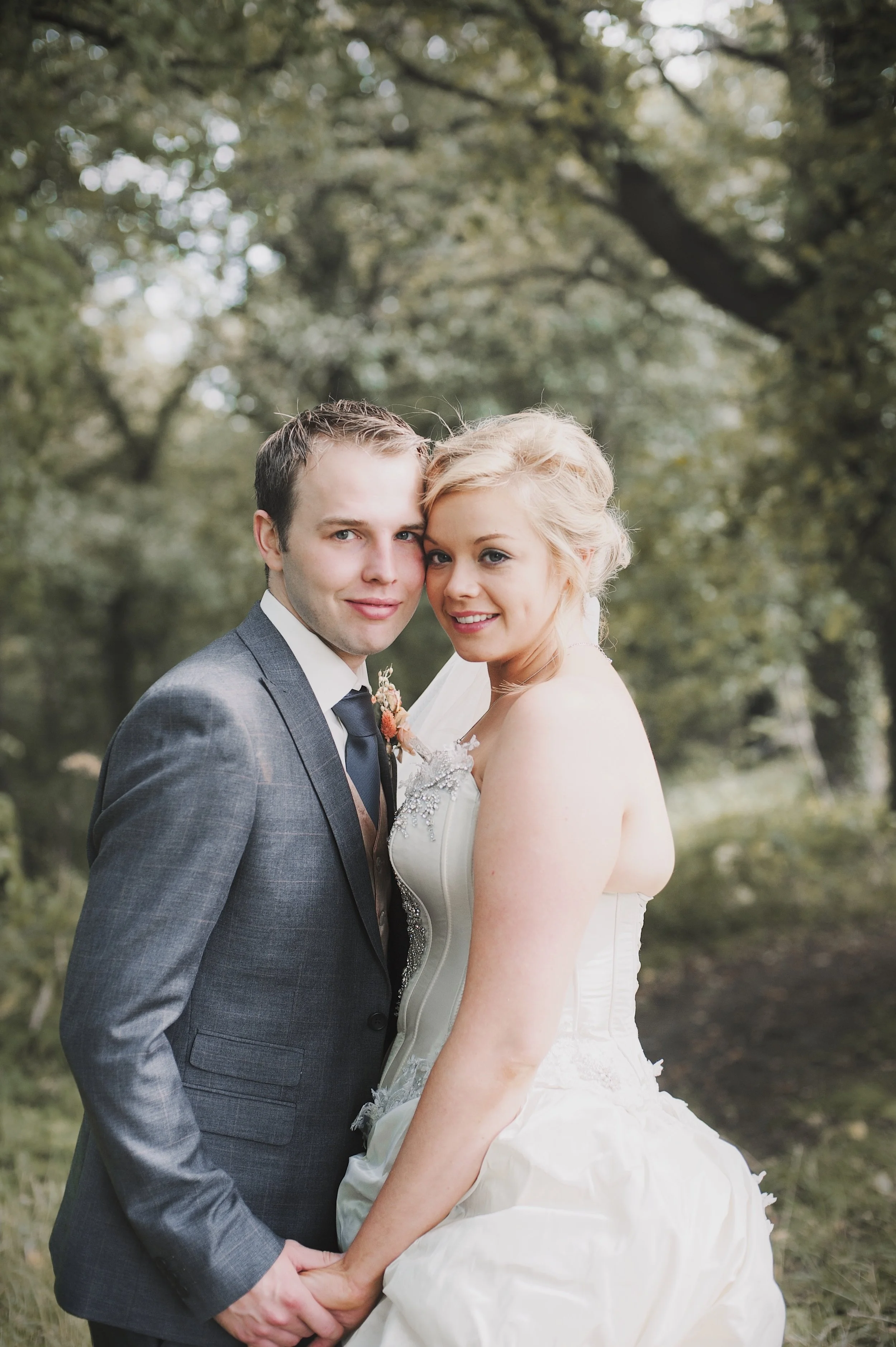 What an amazing day at Lumley Castle, County Durham! It couldn’t have been a more wonderful setting or a more spectacular day! The magnificent castle backdrop and stunning grounds made it the perfect place for getting married. The bride ( my wonderful daughter!) was dressed in a stunning Farage, Paris, wedding gown and chose an antique soft peach and pink palette with hints of deep orange and gold for her wedding flowers. The bridesmaids wore peachy pink corseted tops and cream, tulle full -length skirts, carried dainty sleeping flower posies and wore flower hair clips. The result was a spectacular array of colourful dried blooms that made the day extra special. We used a variety of peach and pink dried and miniture silk roses with two tone hues and matched these with a variety of spectacular dried grasses and herbs, lepidium, nigella, and tiny seed pearls and crystals! Thanks to John Hesford Photography.