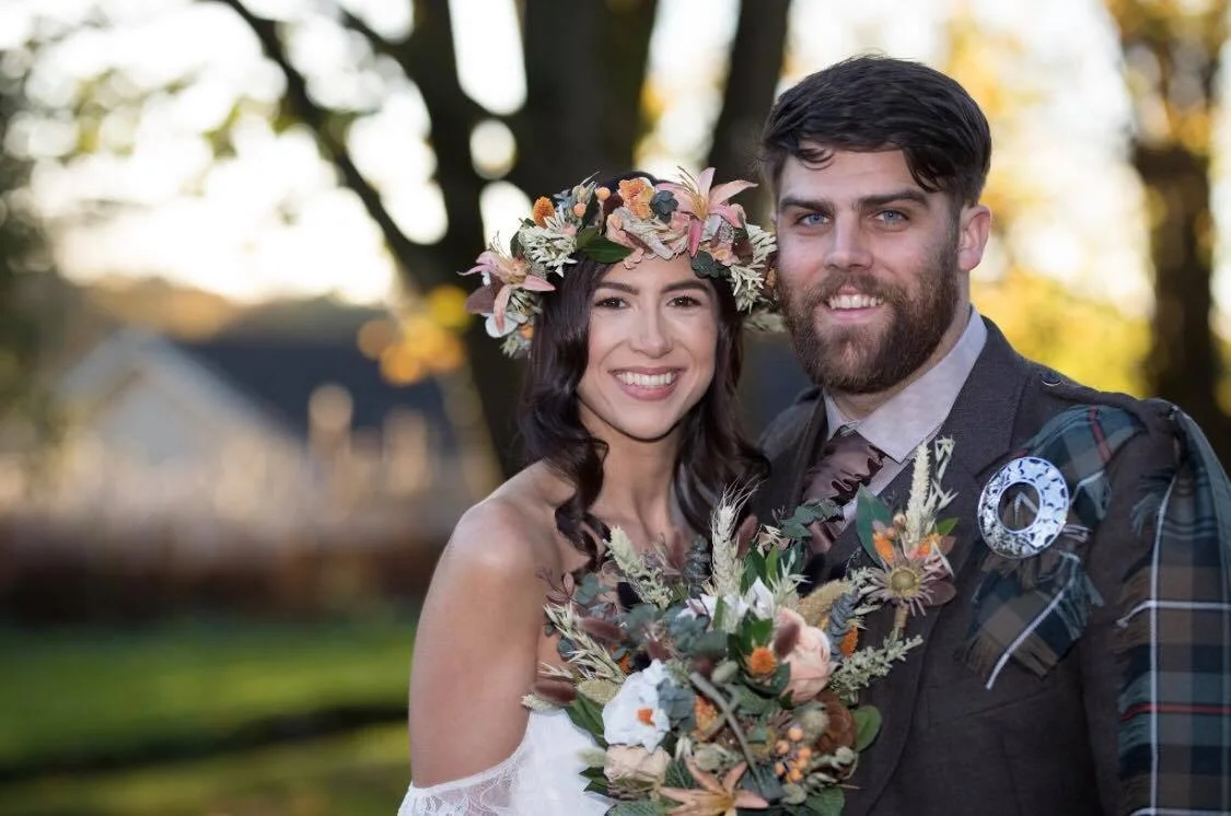 Amy and Scott were married at the beautiful Jacobean mansion, Inglewood House, a wonderful, romantic venue in Stirling, Scotland. Amy chose a stunning, boho country style wedding bouquet with silk and dried coffee, cream and peach flowers, a wide variety of beauiful grasses, seed pods and tiny seed pearls all finished off with palest peach silk ribbon ties. We also made Amy a matching flower crown, bridesmaid bouquets, men's buttonholes and venue table centre decorations for the big day. The Sleeping Flower Company want to thank Amy and Scott for being our customers. We think that your wedding looked totally spectacular!