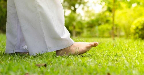 Walking meditation with bare feet in soft grass is a wonderful way to focus our minds on the sensation of each footstep.