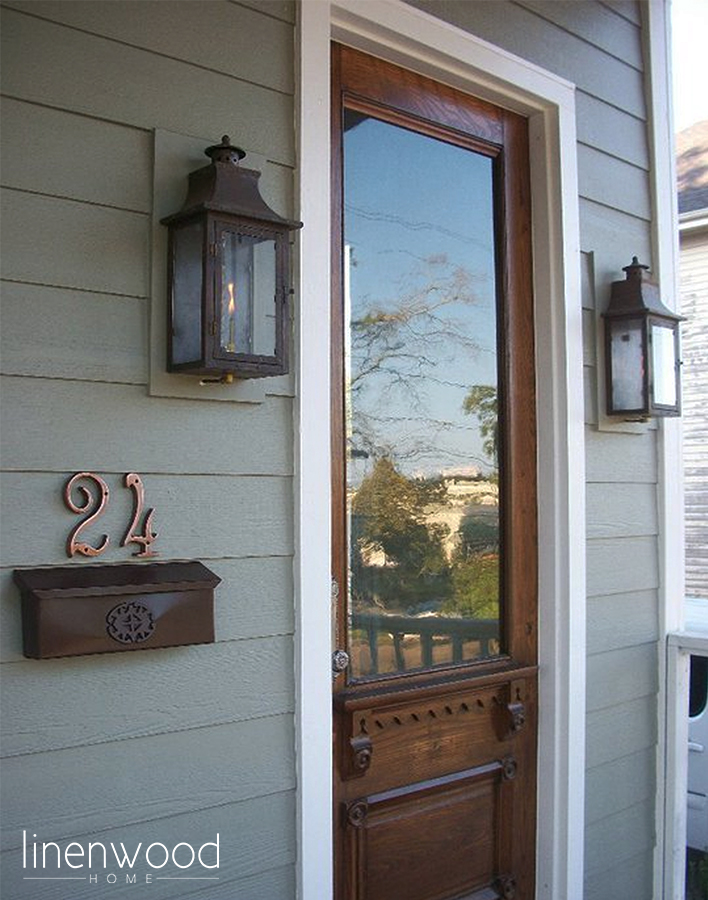 The Brainerd Street House front entrance flanked with copper gas lanterns.