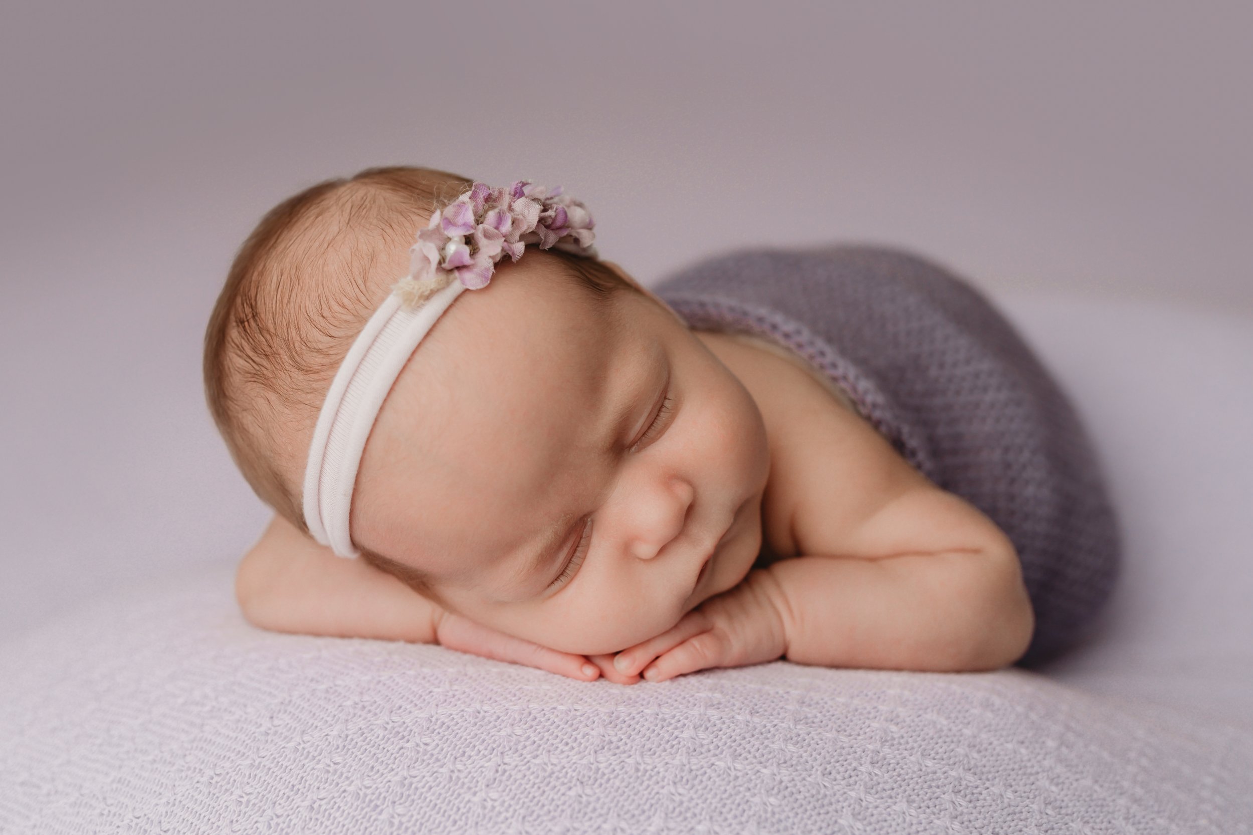 Boca-Raton-Newborn-Photographer-Baby-in-purple-chin-on-hands