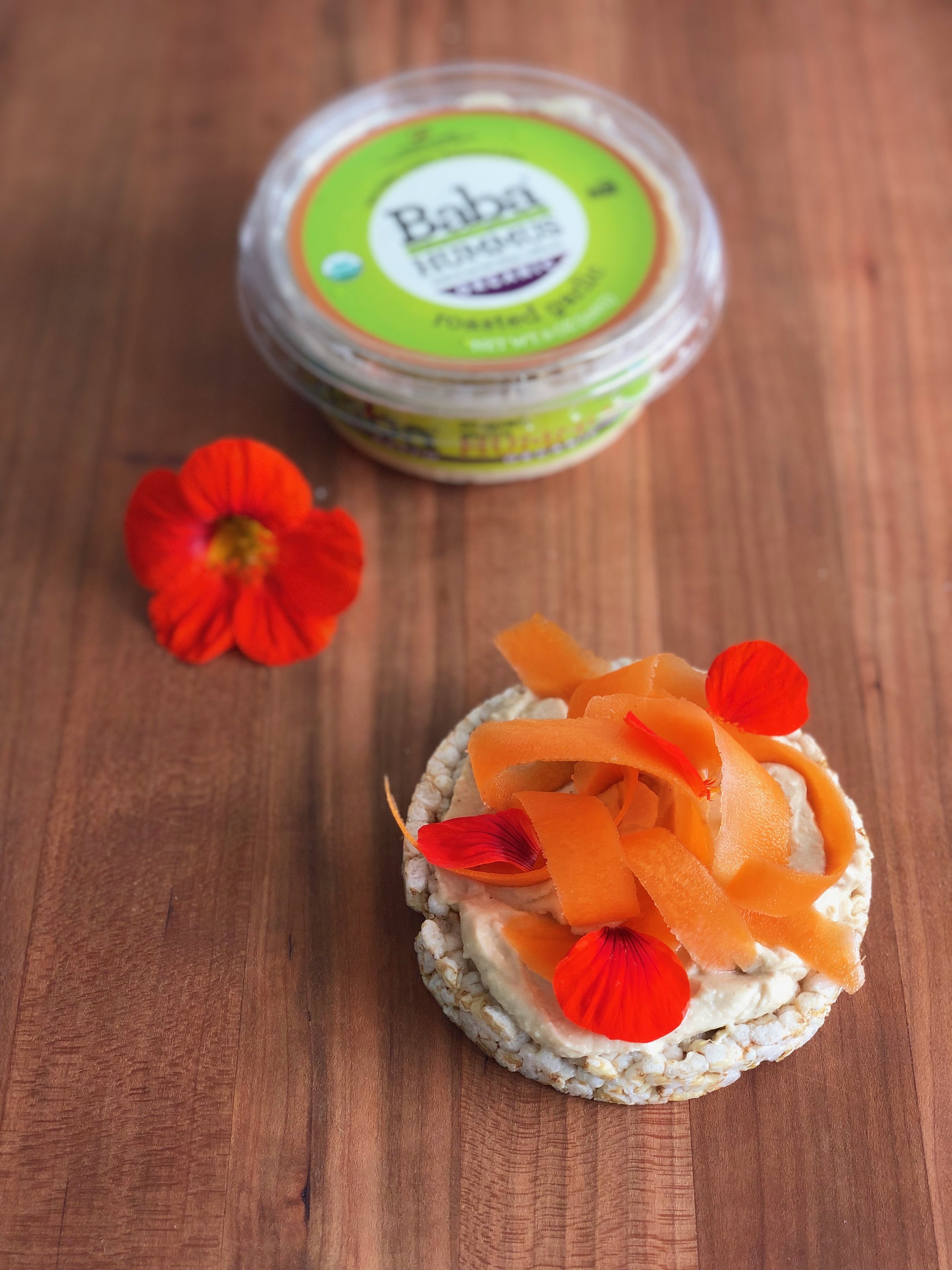 Roasted Garlic Baba Hummus is usually always in my fridge. I loaded up this rice cake with a few spoonfuls and topped it with local carrots from the shop that I quickly pickled. I made my pickling liquid out of apple cider vinegar, sugar, salt, black peppercorns and mustard seeds and poured it over the carrots. We have nasturtiums flowering in the yard so I garnished for a pop of color. I love adding them to salads and even desserts!