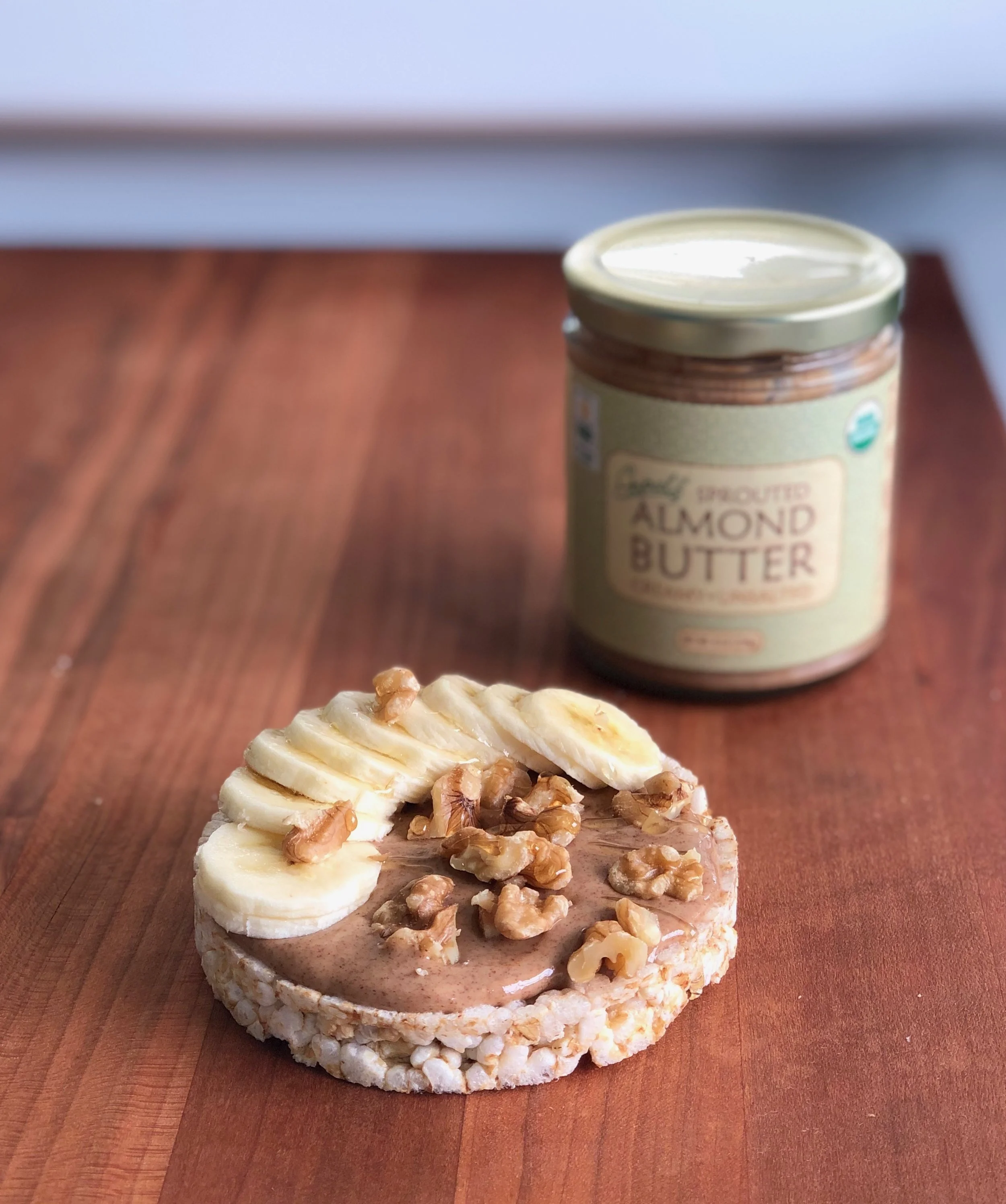 If you have’t tried Gopal’s Sprouted Nut Butters you MUST! I used the Sprouted Almond Butter on this rice cake and it was delectable. It’s a little more pricy than other nut butters at the shop but it’s well worth it. They soak and germinate their organic raw almonds then dry them at very low temperatures. This keeps it super enzyme-rich, nutrient-dense and easily digestible. I added some sliced bananas, raw walnuts and a drizzle of local honey… just because.