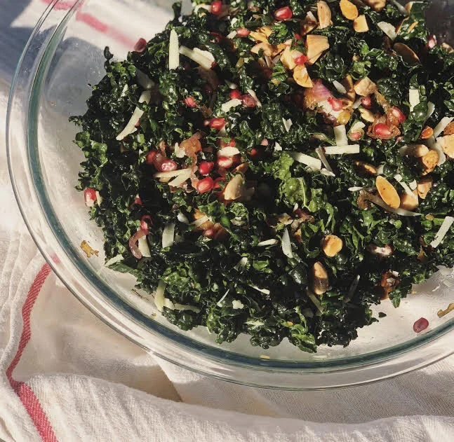 Kale Salad W Rosemary Scented Almonds Pomegranates A Warm Caramelized Shallot Apple Cider Vinaigrette Pacific Health Foods