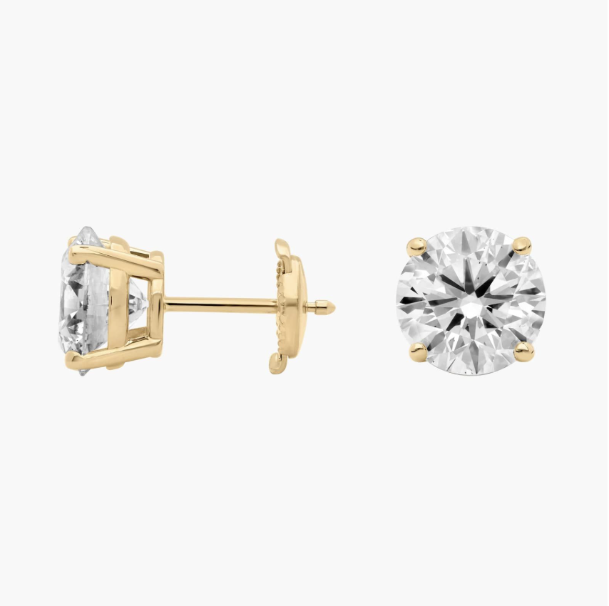 Diamond stud earrings in four-prong yellow gold settings, shown with post and butterfly back