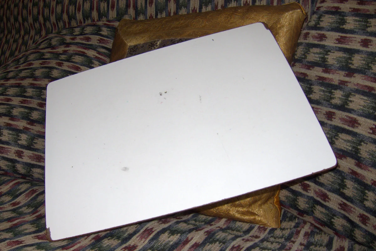 Worn and battered, my writing desk has survived eighteen years of me lugging it around the house.