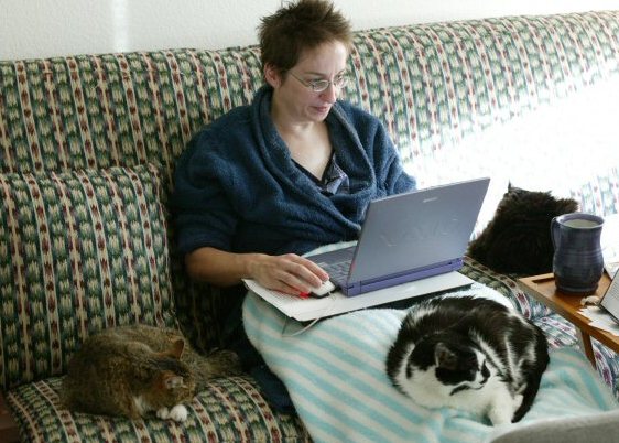 Me and the three cats during my first dive into National Writing Month ( NaNoWriMo ) in 2003. Notice the writing desk under the laptop.