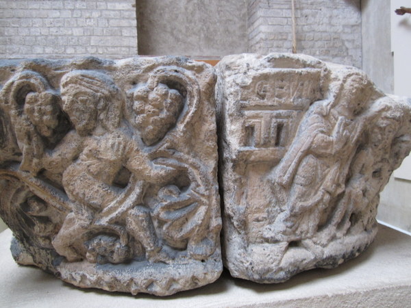 A cracked capital showing crude figures that used to top a column at the Abbey of Saint-Germain-des-Prés, Musée de Cluny / Musée national du Moyen Âge, Paris, France.
