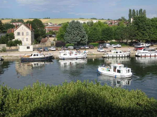 Looking out at the Yonne River from the boardwalk behind the Hôtel Le Maxime. It was a busy port the weekend I was there. Many boats were either traveling the river or tied up at the docks. Auxerre, France. June 2011