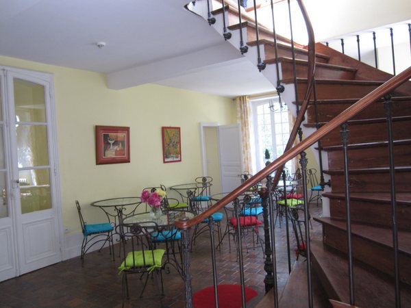 The breakfast room/dining area for guests at the Hôtel Les Grande Chenes. I really felt energized by the bright colors in the morning when I arrived for breakfast. The stairs on the far right led up to a landing off of which was my room as well as several guest rooms. A few rooms were on the first floor off the dining area through the doors on the left of the photo. Saint Fargeau, France. June 2011.