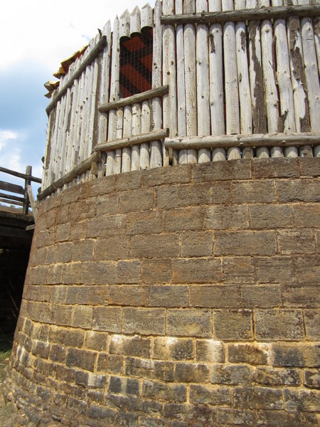 One of the Gate Towers under construction along the curtain wall. The wood construction on top forms the frame for the mortar and stone edifice that will be built around it.