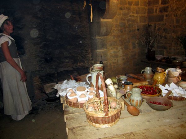 A cook baking bread and pies in the residence kitchen.