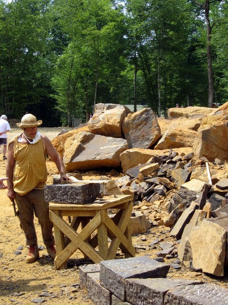 A stonecutter dressing sandstone for use in building the castle walls.