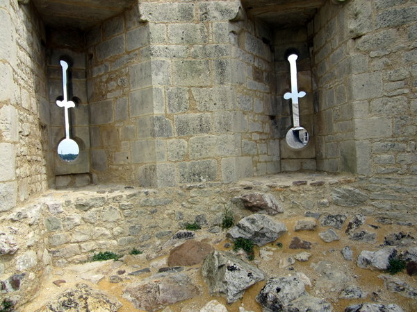 Arrow loops through which archers would let loose their arches looking like they were just carved out of the limestone at the Falaise Chateau.