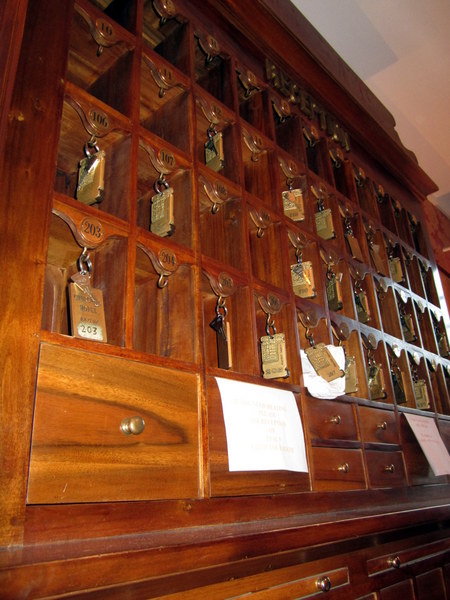 A close-up of the key cabinet on the wall across from the front desk at the Hotel Churchill.