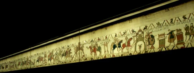 Picture of Bayeux tapestry behind glass at the museum in Bayeux, France. Photo by Dave of Travelin' Tigers , 2002.