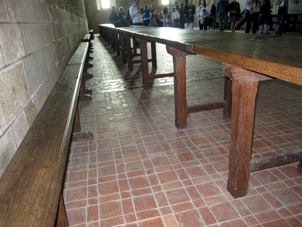The beauty of worn wood, reddish tiles and stone walls in the monks' dining hall.