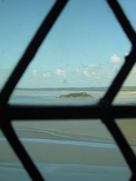 Another, smaller island, Tombelaine, spied through old glass near the main hall.