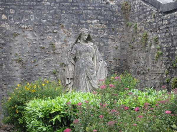 A statue of the Virgin Mary in a garden on my way to see the Bayeux Cathedral.