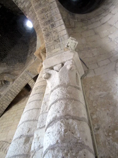 The ovens in the kitchen have ornate capitals on their columns like they were entrances to a great building.