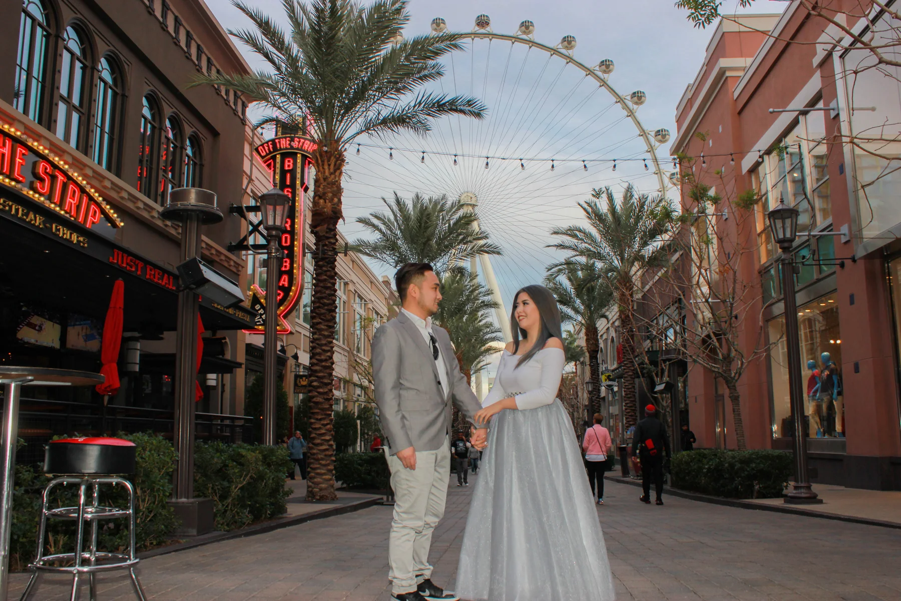 Newlyweds pose in front of the High Roller observation Wheel