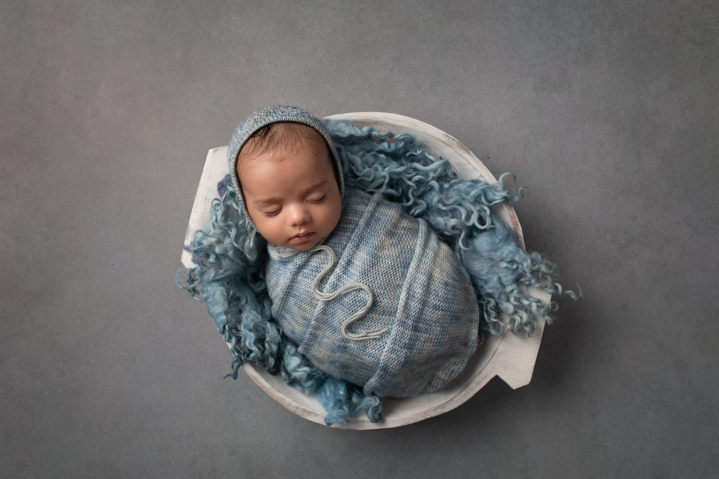  Newborn boy in a bowl with blue fluffy blanket in MK 