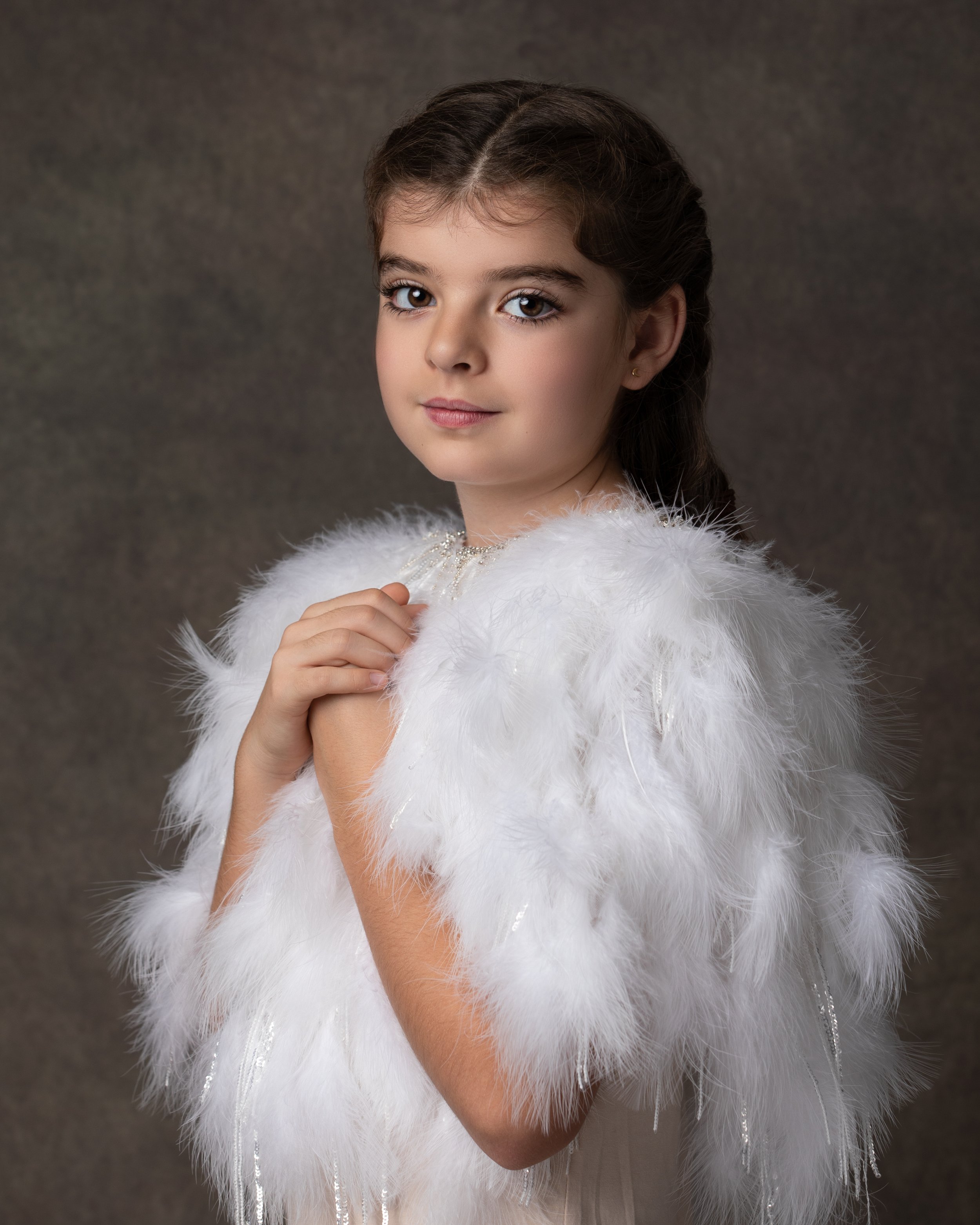  Beautiful girl in a white feather outfit photographed in Bedford studio  