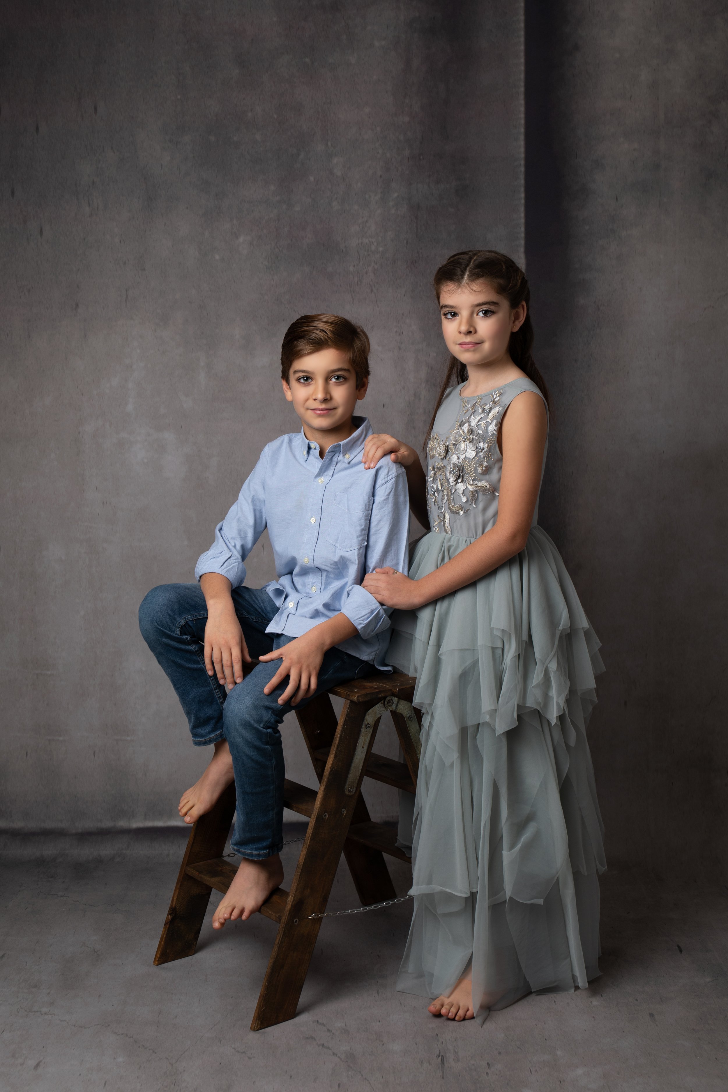  brother and sister in picture in smart clothes in Buckingham studio 