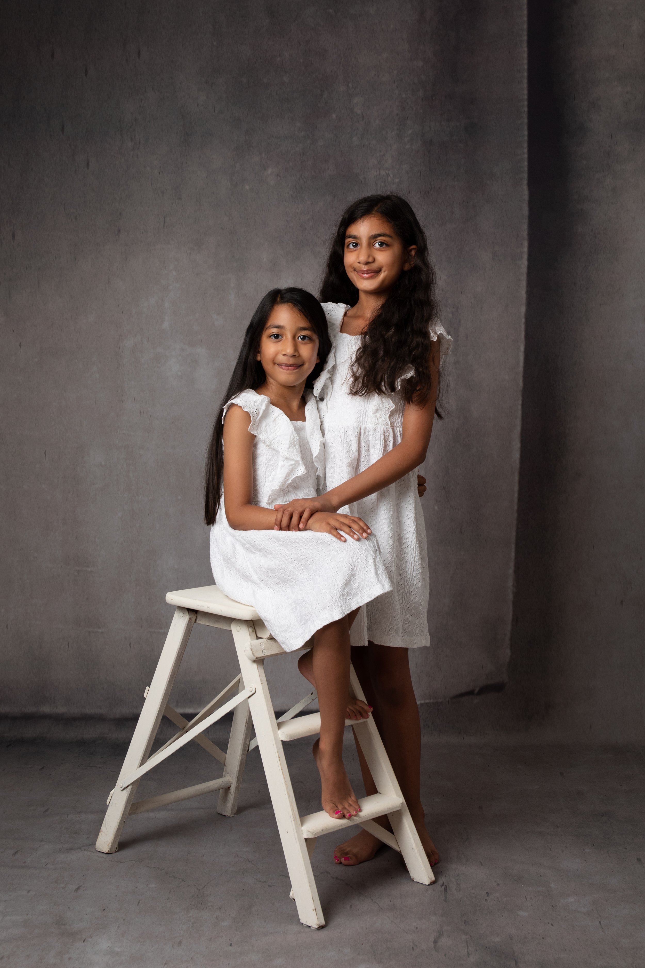  Two sisters posing on white dresses in MK studio 