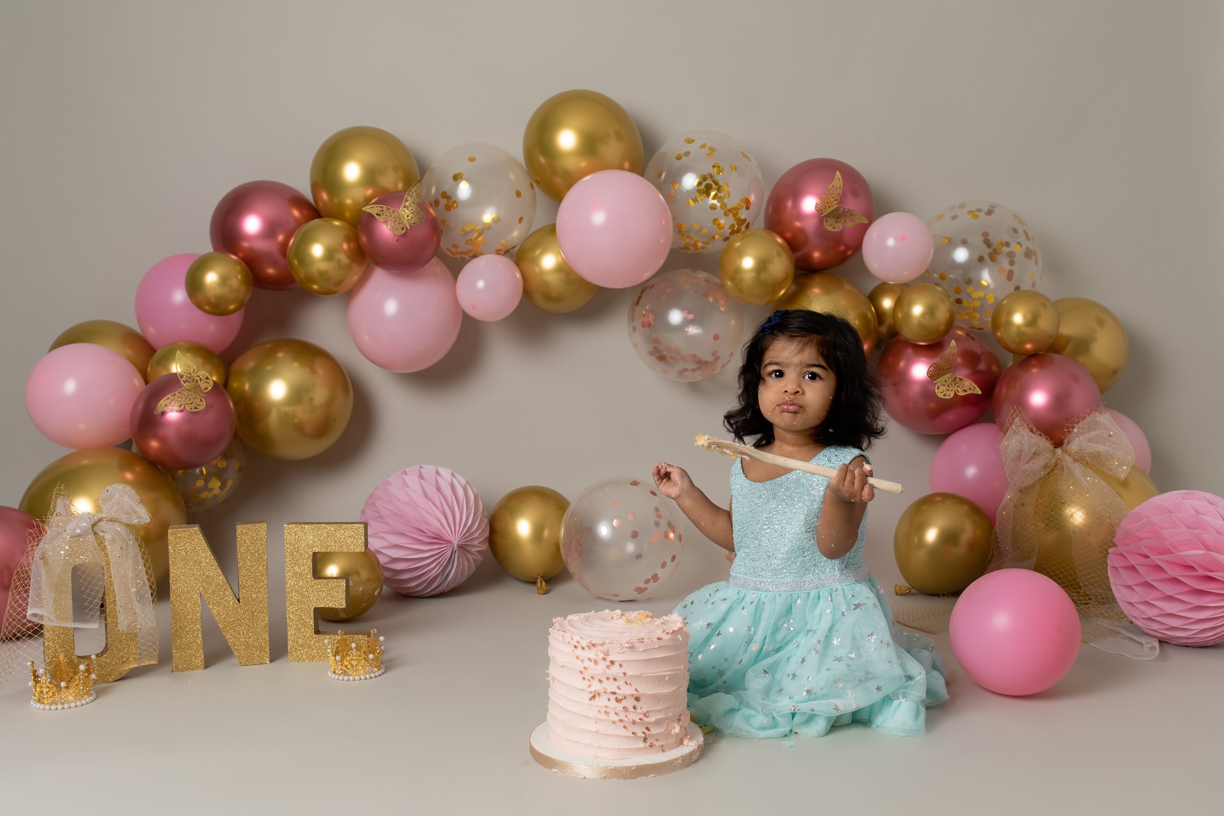  Girl in cute dress with a birthday decorations and balloons and cake in Buckingham 