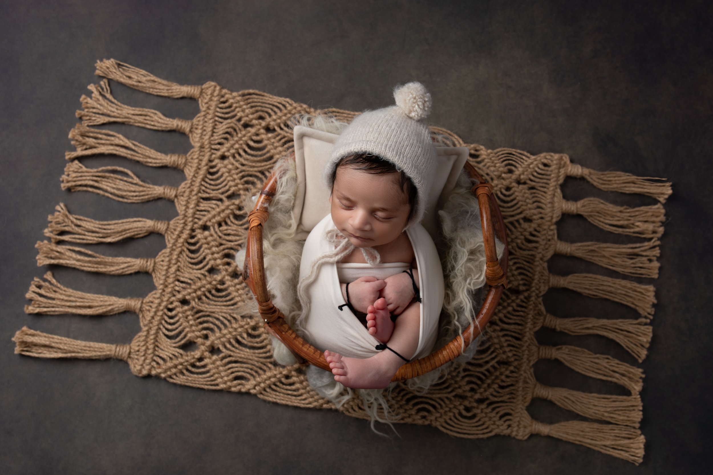  Baby boy sleeping in a basket in cream fluff and cream hat in MK 