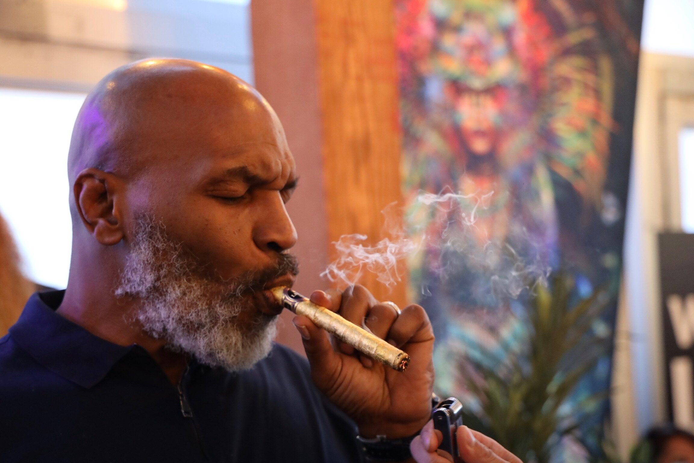  Mike Tyson smoking a 24k Gold Guilded Cannagar. 