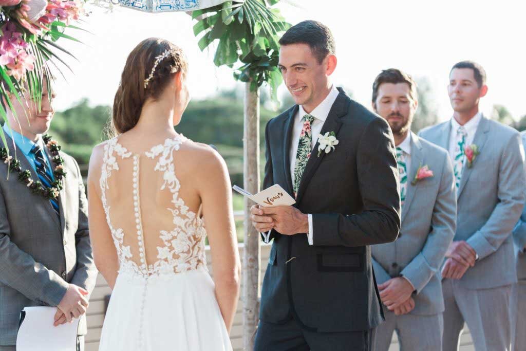 groom-reading-his-vows-queen-kapiolani-hotel-Rae-Marshall-Photography.jpg